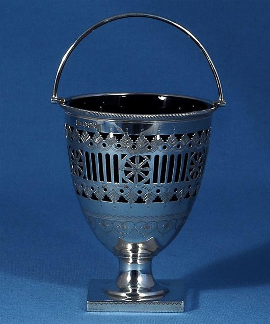 A late Victorian silver swing handled sugar basket with a blue glass liner, by Atkin Brothers, height 165mm, weight 4.9oz/154grms.